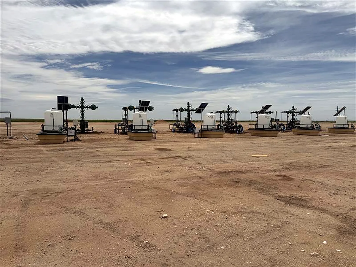 Chemical injection skids at gas wellheads in an oilfield